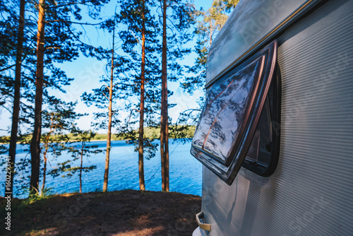 Close up part of camper van or caravan RV truck with window open parking by the sea