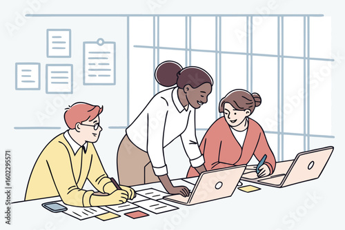 Team collaboration at a modern workspace with laptops and notes, showcasing creativity and problem-solving among colleagues during a brainstorming session