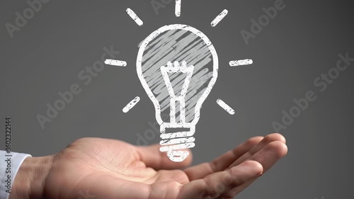 Hand Presenting a Chalk Drawn Lightbulb on Gray Background Symbolizing Idea Generation and Creative Solutions