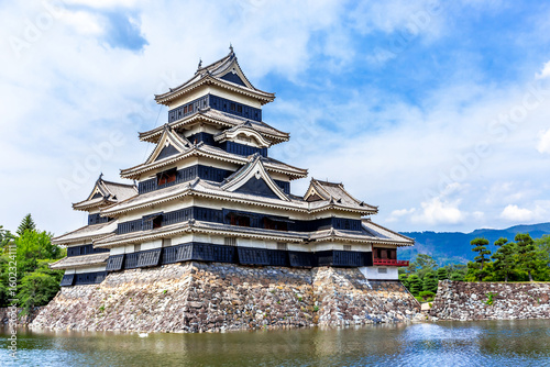 Matsumoto Castle or Crow Castle and the red bridge in summer is one of Japanese premier historic castles in Honshu. Landmark and popular for tourists attraction in Matsumoto city, Japan