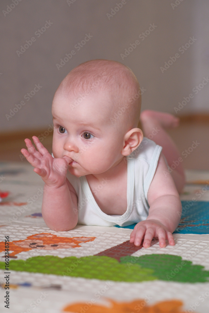 An adorable baby is crawling cheerfully on a vibrant and colorful playmat, exploring joyfully An adorable baby is crawling cheerfully on a vibrant and colorful playmat, exploring joyfully