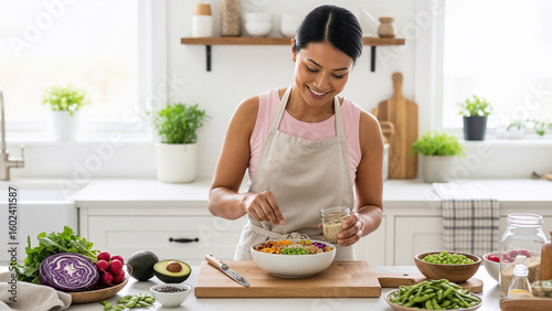 Smiling woman preparing a healthy vegan salad with fresh vegetables in a bright kitchen, home cooking nutrition scene, wellness and vegetarian lifestyle food preparation concept