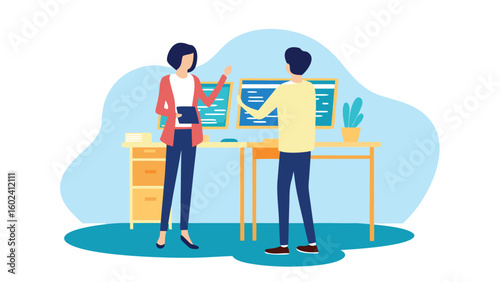 Two colleagues discussing work in an office environment with computers and a plant on the desk nearby