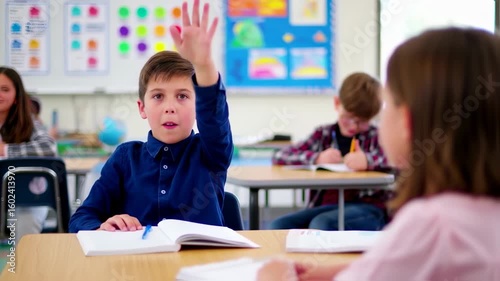 Boy raising hand in classroom