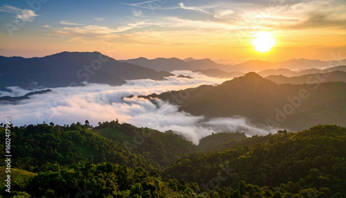 A breathtaking sunrise illuminates rolling mountains and a sea of clouds, creating a serene and majestic landscape.