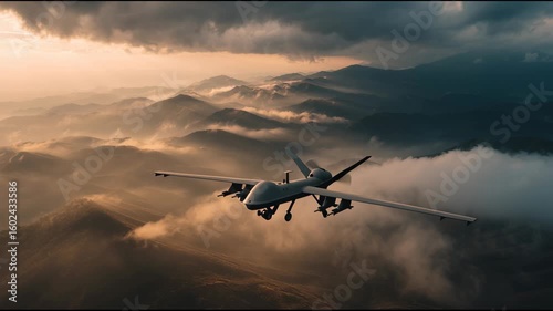 An armed drone flies over rugged mountain terrain as low-hanging clouds drift below. The sunset casts a golden hue over the landscape, creating a striking visual