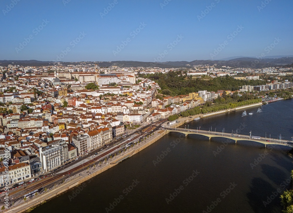 Obraz premium Aerial view of Mondego River and old town of Coimbra, Portugal. On the banks of the river Mondego, Coimbra is famous for its University, the oldest in Portugal and one of the oldest in Europe.