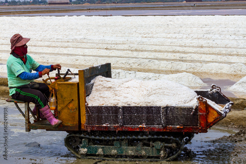 Pyramids of sea salt ready to be harvested in a salt farm at sunrise. Used as a seasoning in food, cosmetics and for food preservation.
