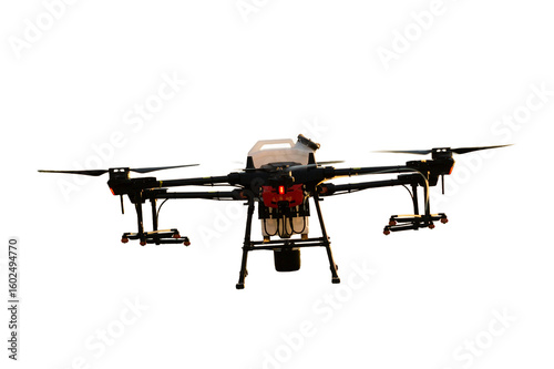 Agricultural technology smart farm concept. Farmer technicians remotely fly agricultural drones to fly to spray fertilizer in fields.