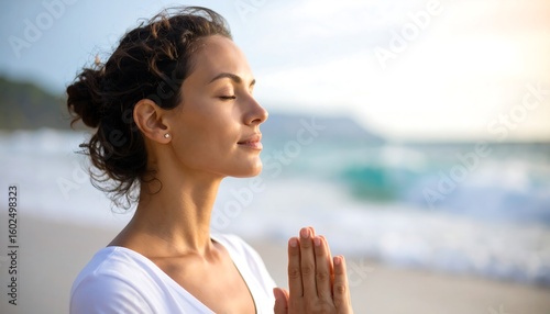 Woman meditating by the ocean (1)