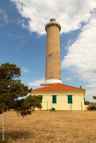 Veli Rat Lighthouse, Croatia’s tallest, stands on Dugi Otok's rocky shore. Its ochre tower, pine-fringed coast, and turquoise sea make it a stunning, timeless subject for coastal photography.
