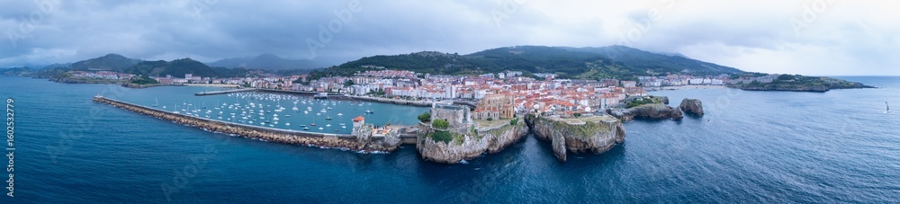 Fototapeta premium Aerial view from a drone of the Castro Urdiales port, the Church of Santa María, and the Santa Ana Castle Lighthouse. Castro Urdiales Municipality. Cantabrian Sea. Cantabria. Spain. Europe.
