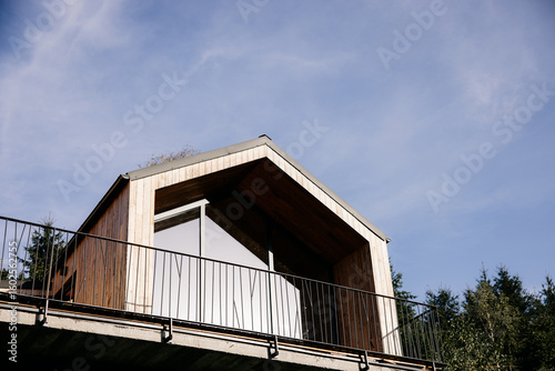 Wallpaper Mural Modern wooden cabin with balcony overlooking forest and blue sky Torontodigital.ca