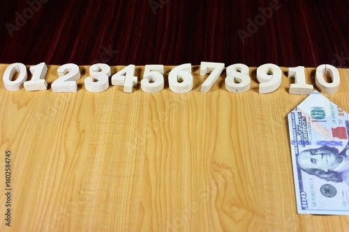 Stop motion animation of dollar bills and numbers.