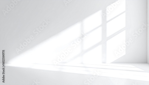Sunlight casts shadows on a white room