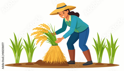 Smiling female farmer in a straw hat and boots harvesting a sheaf of golden rice stalks.