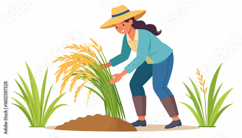 Smiling female farmer in a straw hat and boots harvesting a sheaf of ripe golden rice.