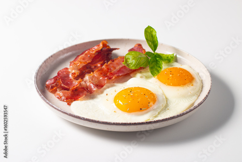 Delicious traditional English breakfast with fried eggs and bacon
