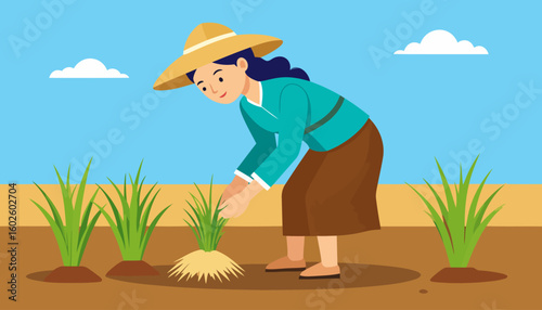 Smiling female farmer with dark hair and a straw hat planting rice seedlings.