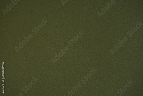 Dark green matte surface texture with subtle grain and minimal irregularities. Simple solid background ideal for design, graphics, and 3D materials.