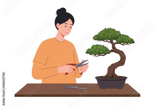 A smiling woman with her hair in a bun carefully prunes a lush green bonsai tree with shears at a wooden table.