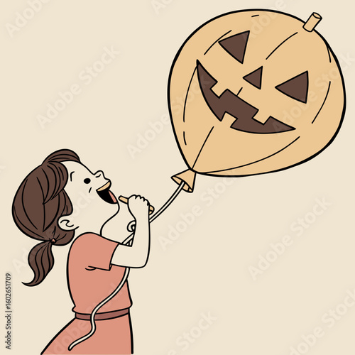A girl blowing up a halloween balloon with a jack o lantern face while smiling with a ponytail and dress