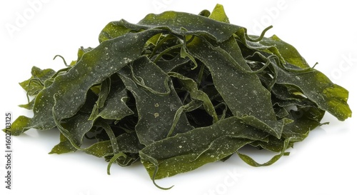 Pile of dried green kelp seaweed leaves with white speckles on a white background