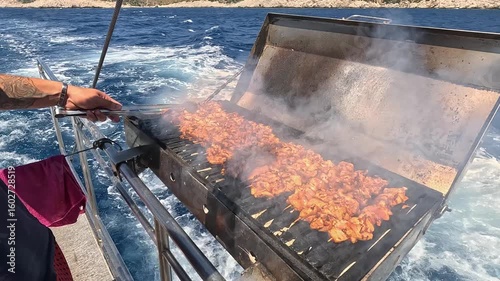 Meat and chicken are grilled on the stern of the Kaş, Kekova, and Kaleköy tour boat. The blue and sparkling sea is in the background.