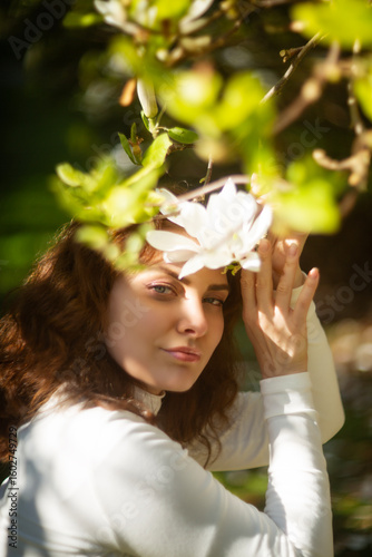 An Elegant Woman is gracefully surrounded by Vibrant Blossoms in a Beautiful Natural Outdoor Setting