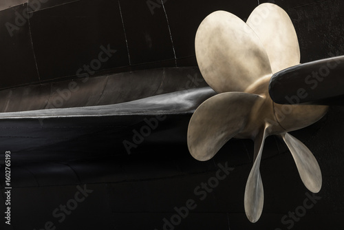 Ship Propeller Close-Up with Black Submarine Boat Hull Background