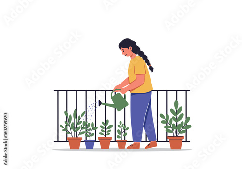 A woman with a braid is watering potted plants on a balcony with a green watering can, tending to her garden.