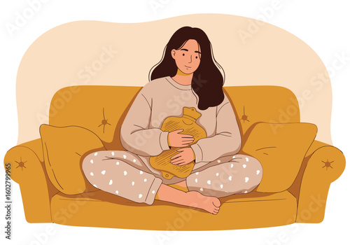 Woman on a mustard yellow couch holding a heating pad, appearing thoughtful and possibly experiencing discomfort.