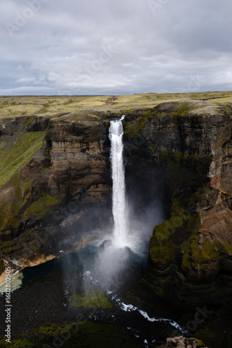 Majestic Haifoss waterfall cascades down rocky cliffs in Icelands stunning landscape