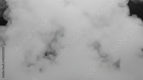 Abstract white smoke clouds swirl with light on a dark black background, resembling a mysterious sky
