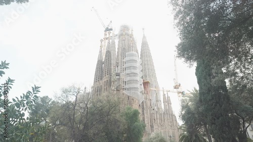 A stunning view of a remarkable architectural structure in the midst of construction, surrounded by lush greenery. This image captures the intricacies of design and the grandeur of the building proces