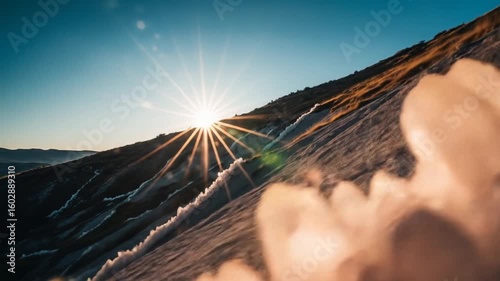 Sunrise over snowy mountain slope with crystals