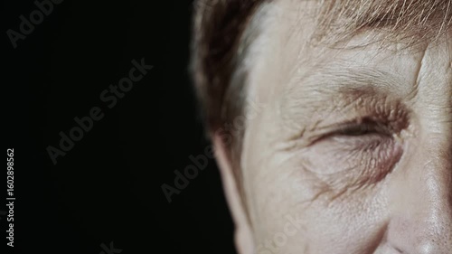 Close-up of an elderly woman's eyes, showing fine lines, textured skin, and a thoughtful gaze. The beauty of aging, life experience. Emotional depth. Natural lighting and realistic details. 