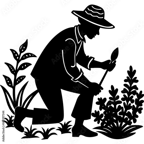 Farmer kneeling and working in a garden with plants