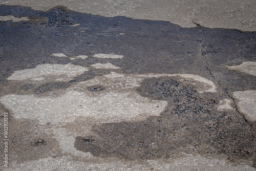 water spilled on a rough and dirty concrete floor. wet concrete.