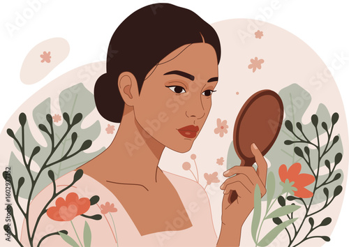 Beautiful woman holding hand mirror looking at her reflection. Self love and body positivity concept with natural elements for beauty, natural cosmetics