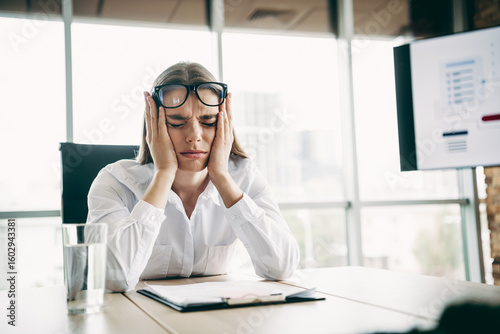 Photography Stressed businesswoman in a modern office struggling with work pressure and chal
