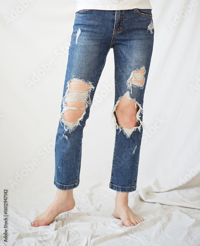 a woman in torn jeans.

