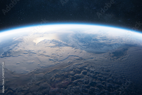 Fototapeta Naklejka Na Ścianę i Meble -  Stunning view of Earth’s atmosphere and cloud formations from space. The planet’s curvature is visible against the dark starry sky, showcasing the beauty and fragility of our planet.