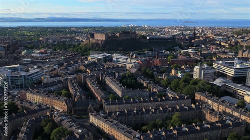 Aerial video of Edinburgh skyline with the iconic Castle on the Rock and distant sea views in the background.