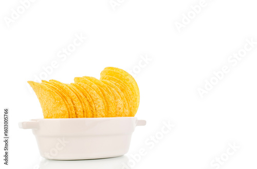 Crispy potato chips isolated on white background, close-up.