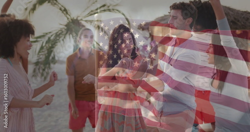 Dancing friends wearing summer attire together on sandy beach at sunset, with American flag overlay