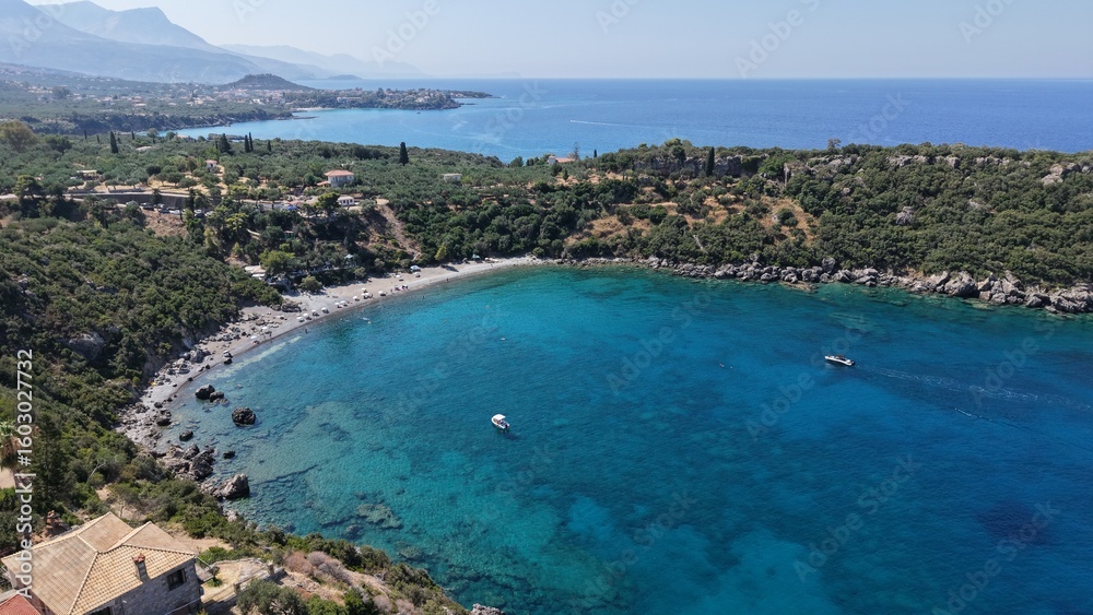Aerial View of Secluded Beach Cove with Turquoise Waters in Mani Peninsula, Peloponnese, Greece, Delfinia beach Aerial View of Secluded Beach Cove with Turquoise Waters in Mani Peninsula, Peloponnese, Greece, Delfinia beach