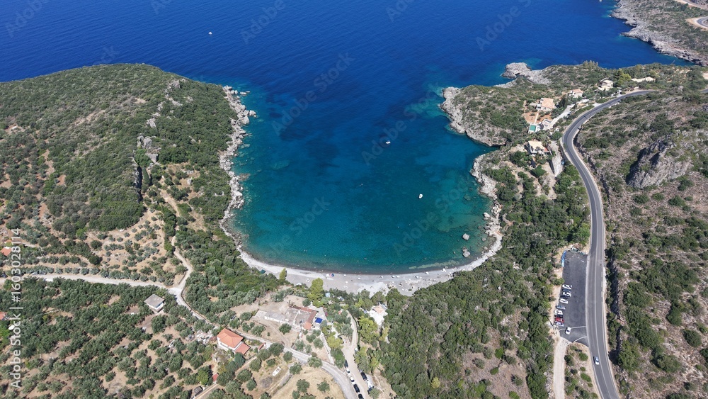 Obraz premium Aerial View of Secluded Beach Cove with Turquoise Waters in Mani Peninsula, Peloponnese, Greece, Delfinia beach