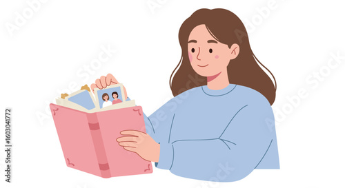 Woman looking at photo album filled with memories