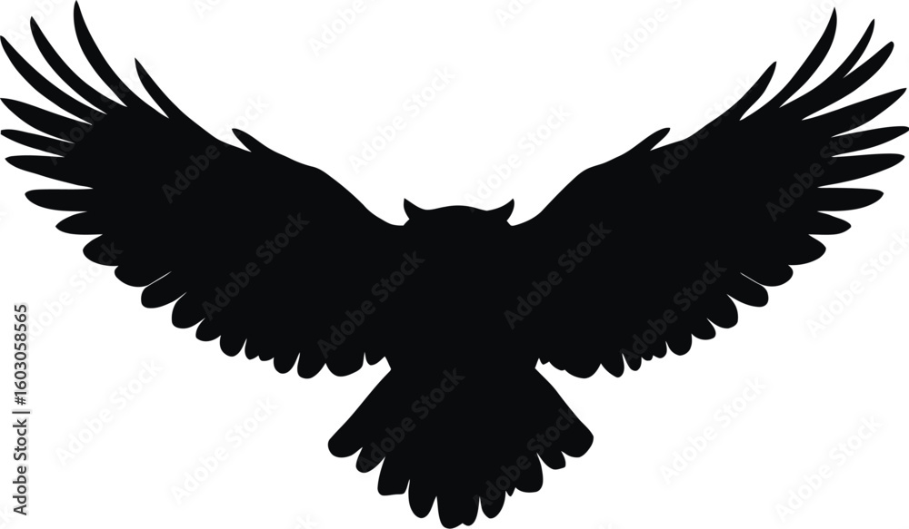 Obraz premium A dramatic, black silhouette of an owl in mid-flight, with its wings fully extended.